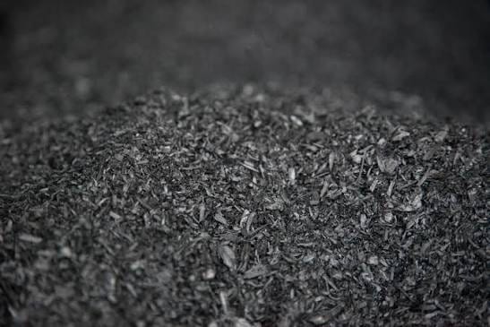 Coarse black biochar flakes