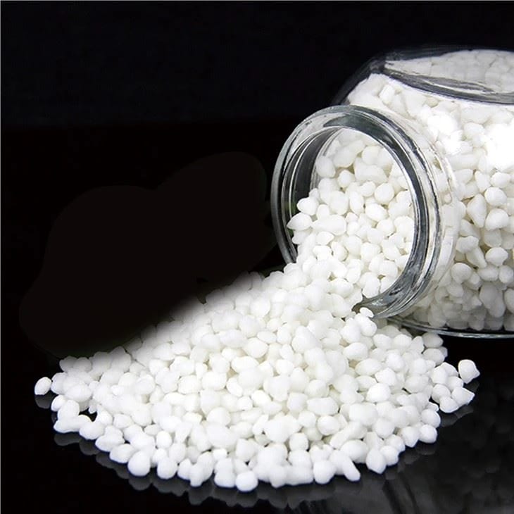 White magnesium sulfate granules spilling from a jar