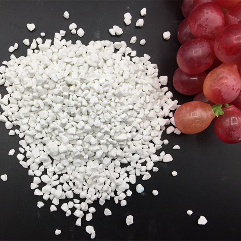 White granular muriate of potash beside red table grapes