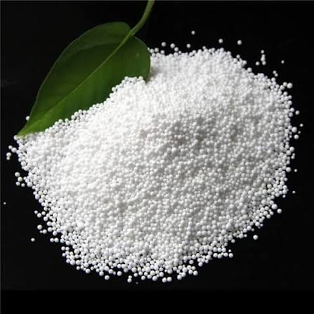 White potassium nitrate prills with green leaves