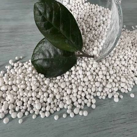 Off-white zinc sulfate granules spilling from a jar